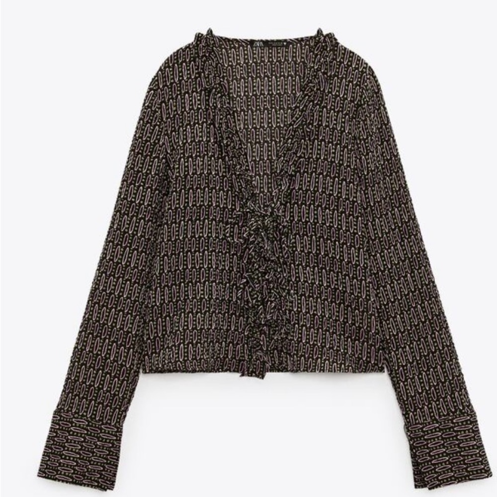 Beautiful V-neck shirt with tie and long sleeves. Ruffle details.